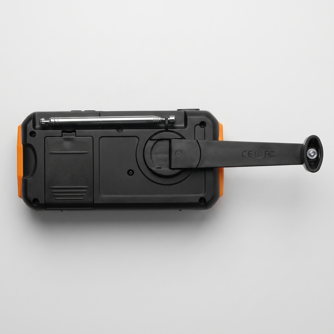 Back of the hand crank radio with telescoping antenna, AAA battery compartment and crank