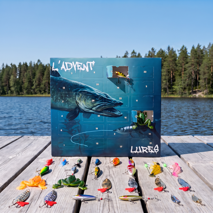 Fishing advent calendar box standing on a wooden jetty by a lake, with the 24 included fishing lures spread out in front of it