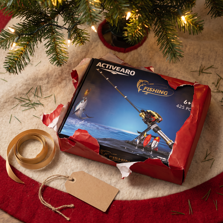 Fishing rod building kit box sliding out of Christmas wrapping paper
