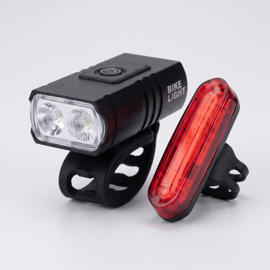 Rechargeable front and rear bike light set on a light gray background