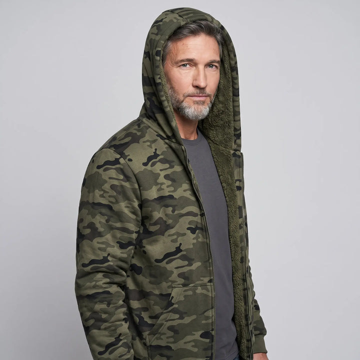 Men's camo hoodie worn with the sherpa lined hood up, three-quarter view