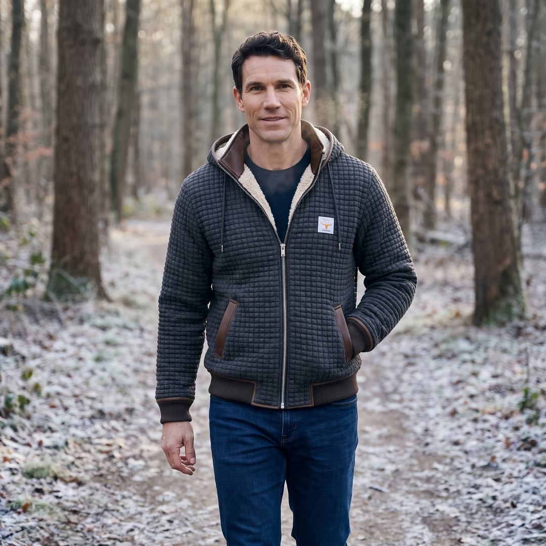 Man wearing the dark gray sherpa lined quilted jacket on a frosty forest trail