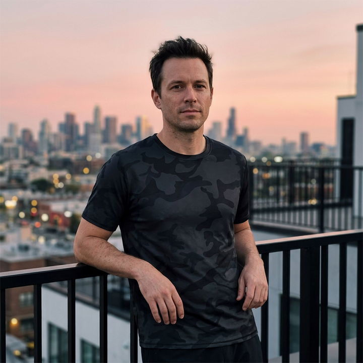 Men's Camo T-Shirt Black - male model on rooftop with city skyline at sunset