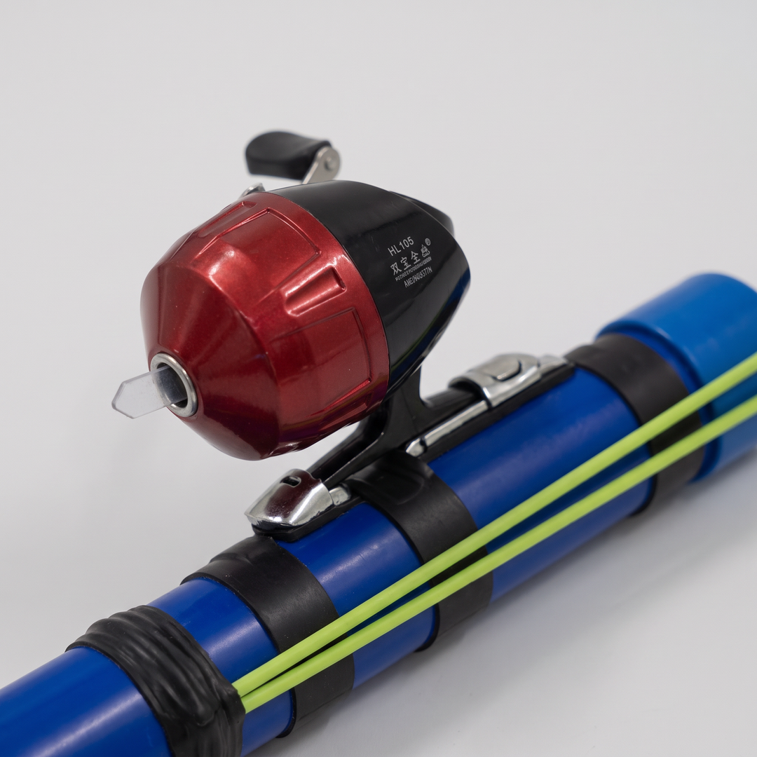 Close-up of the spincast reel in the metal reel seat of the slingshot fishing rod