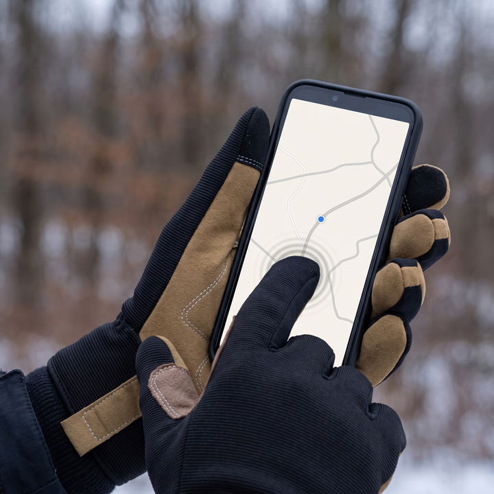 A gloved thumb working a phone screen without removing the glove