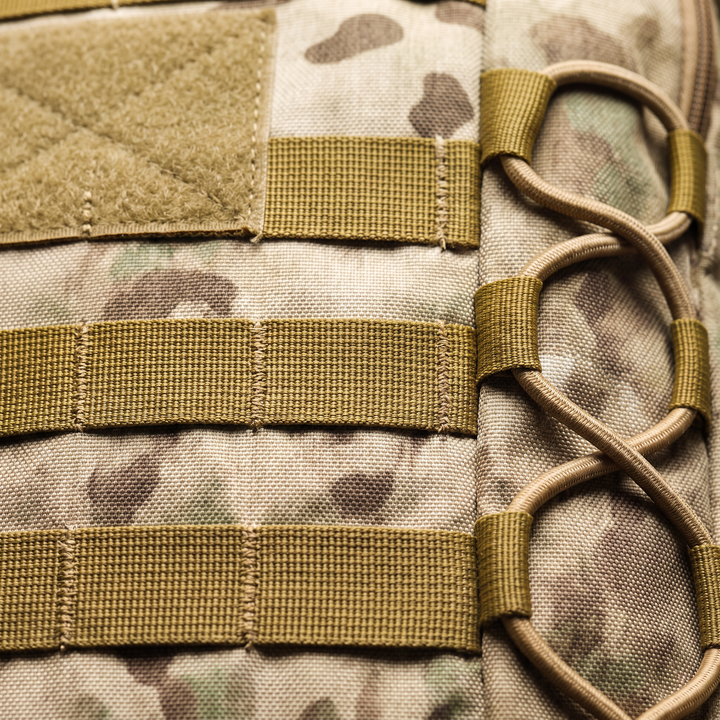 Close-up of the MOLLE webbing rows and the bungee flank lacing