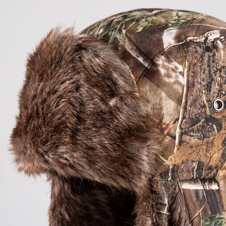 Close-up of the faux fur brim and metal crown eyelet on the camo trapper hat