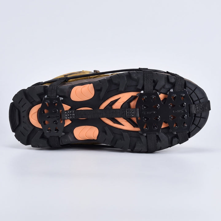 Underside of a walking boot with microspikes, spike plates under the forefoot and heel