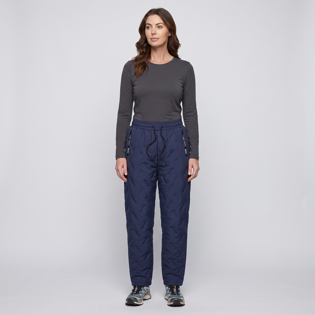 Woman wearing blue quilted winter pants, full length