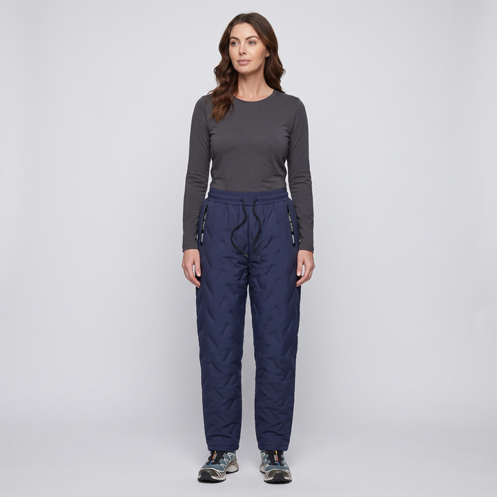 Woman wearing blue quilted winter pants, full length
